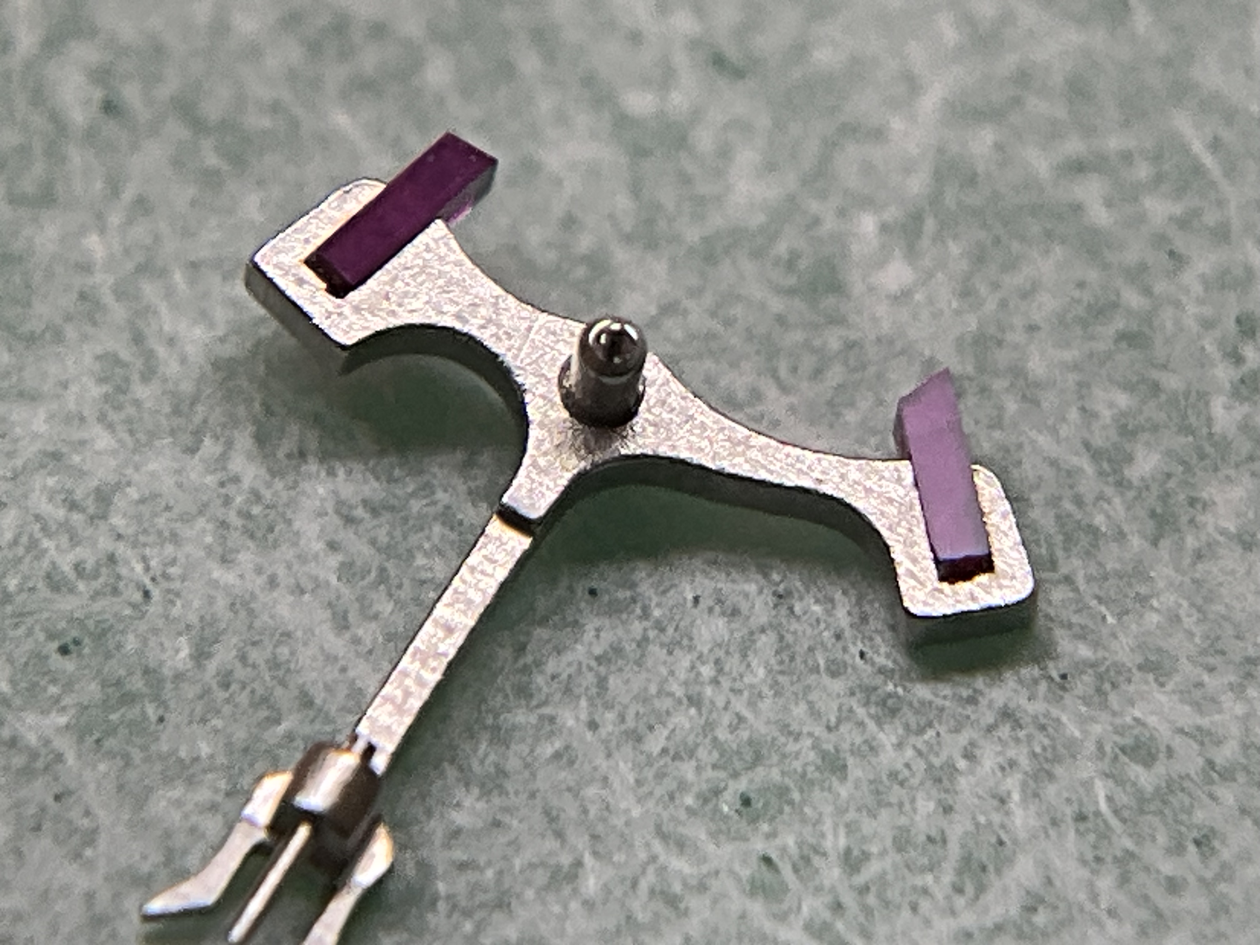 The pallet fork, its ruby stones reset in fresh shellac.