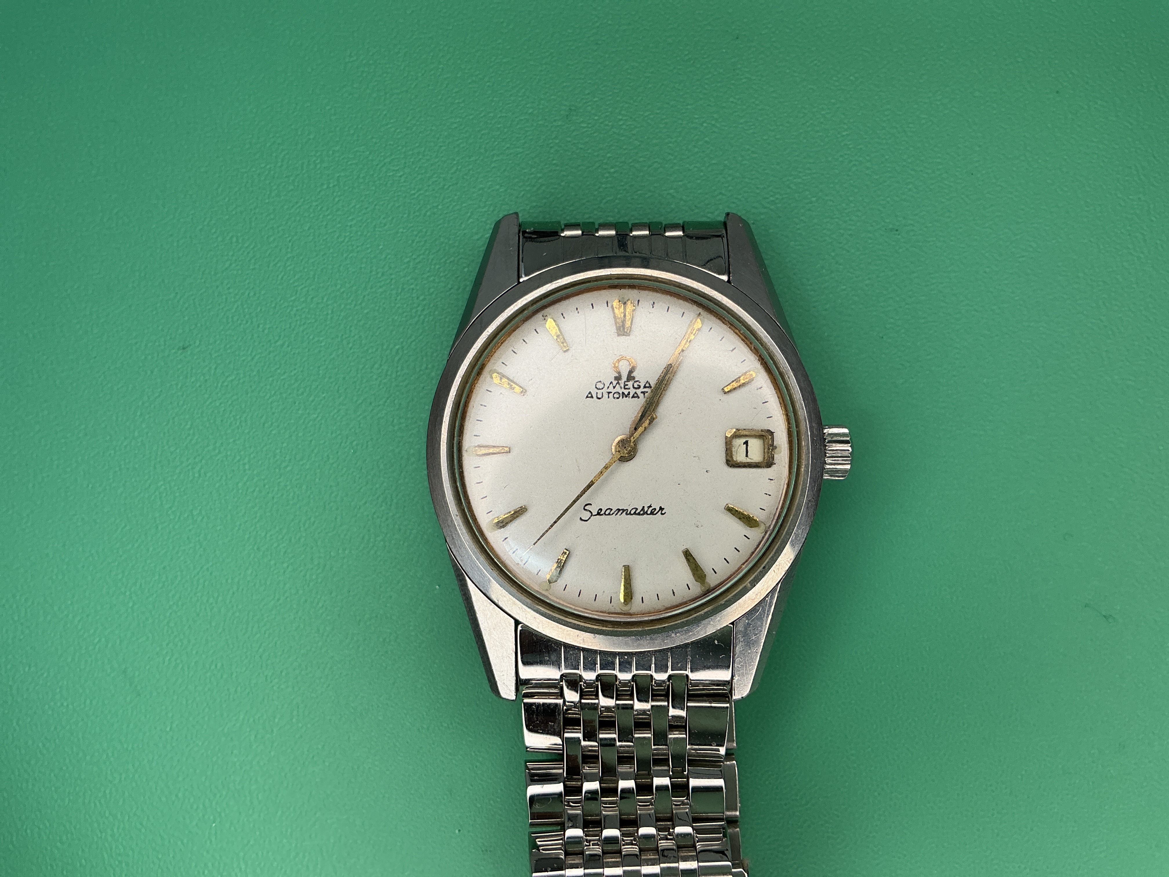 As received — the Omega Seamaster on its beads-of-rice bracelet.
