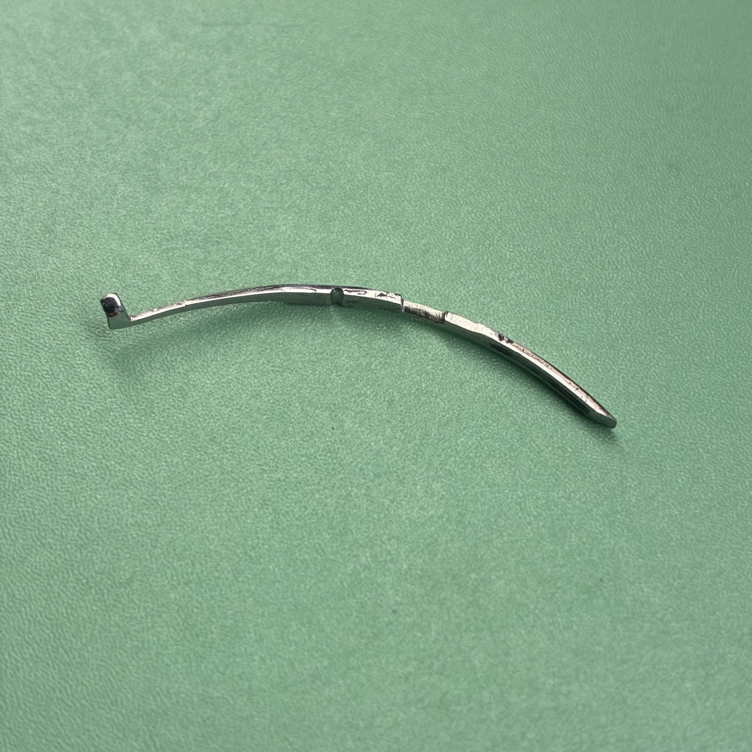 The non-original second hinge spring, reworked by hand.