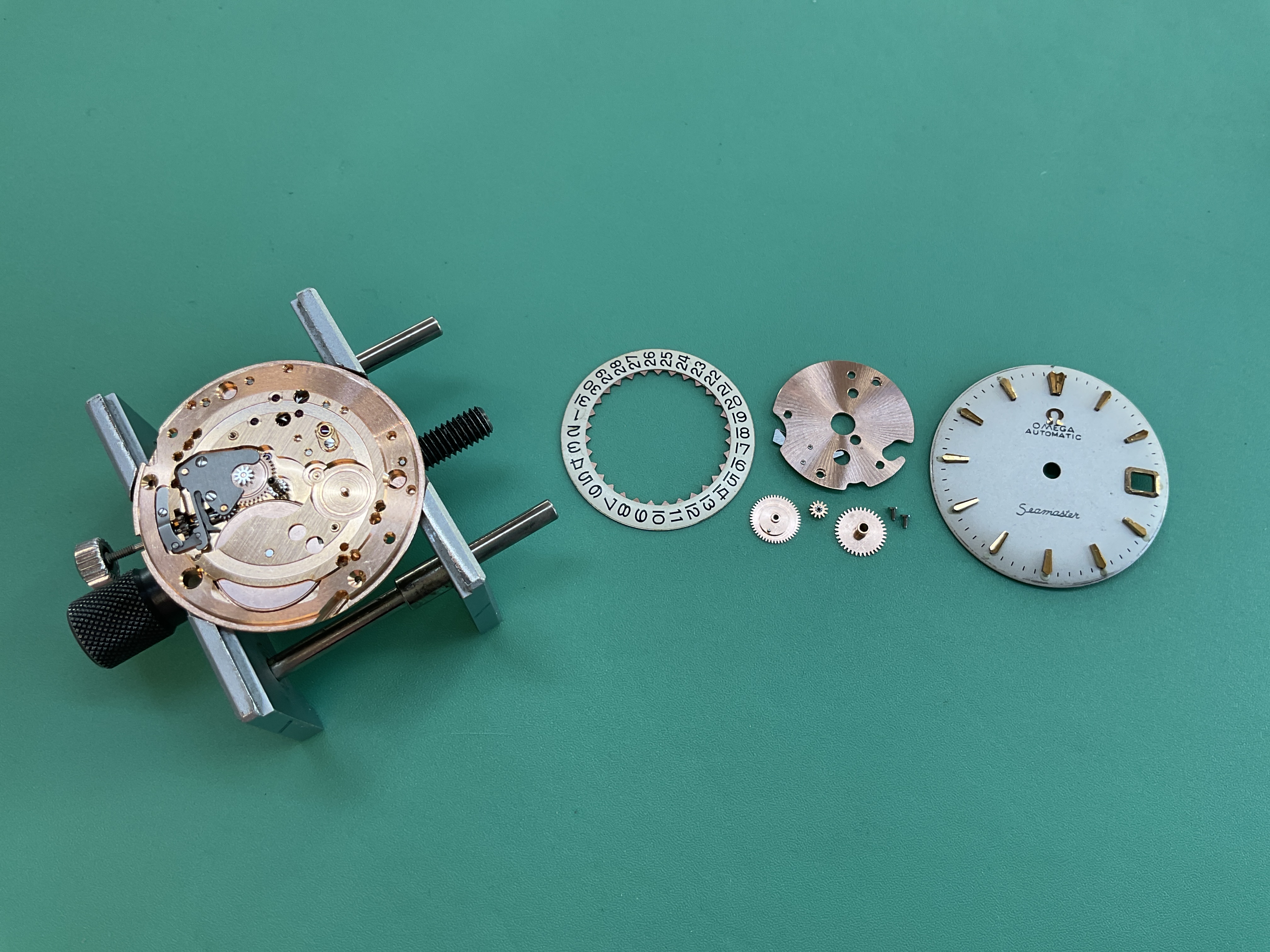 The calendar plate and date wheels laid out for dial-side reassembly.